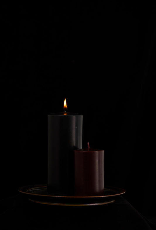 Two candles on a plate.