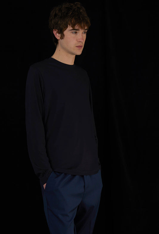 Man wearing blue top and blue trousers.