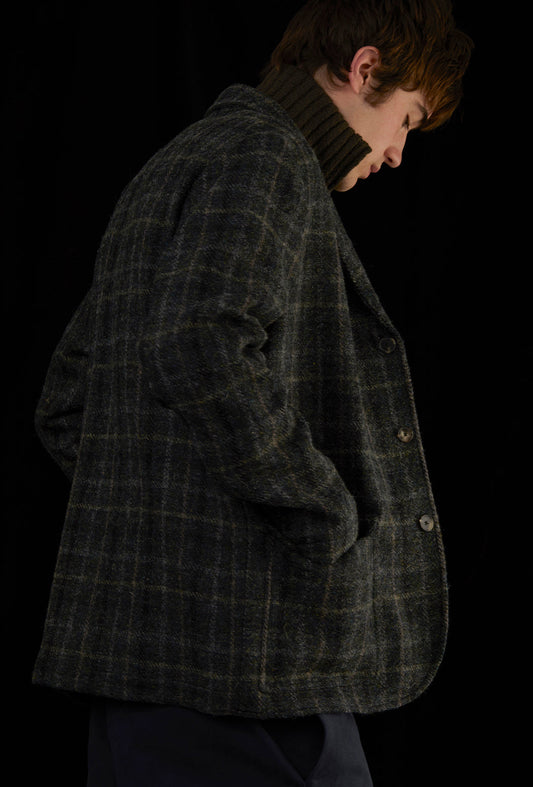 Man wearing a green coat and red scarf.