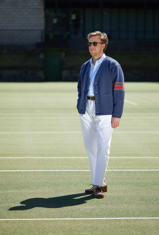 Man Standing in White Trousers