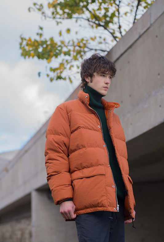 Flynn wearing the Crescent Down Works Classico Parka in Rust
