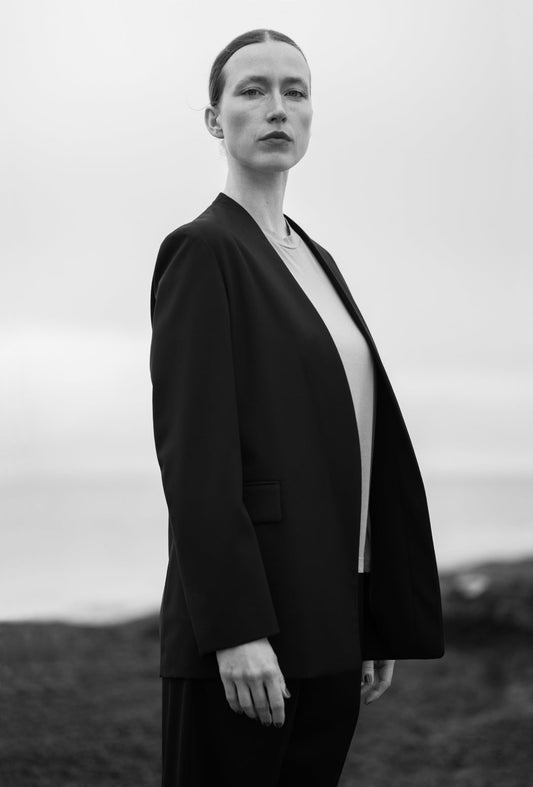 Anna wears Aton Compact Wool No Collar Jacket and  Aton Compact Wool Tapered Tucked Pants in Black with  Aton Fresca Boy's Fit Garment Dyed No-Sleeve T-Shirt in Fuscha Pink