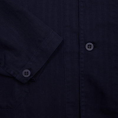 Robert Resca workwear-inspired jacket with two outer flap pockets, internal patch pockets, full-button closure, with a shirt-style collar. Garment dyed in a soft cotton/linen with a tonal herringbone pattern.   60% Cotton, 40% Linen.