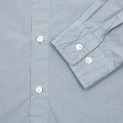 Sage de Cret Cotton Shirt in Saxe is a classic long-sleeve shirt in organic cotton broadcloth. Relaxed cut with curved hem, one chest patch pocket and finished with mother of pearl buttons. Garment washed to give intentional creases for that 'worn in' look.  100% cotton.  Made in Japan.