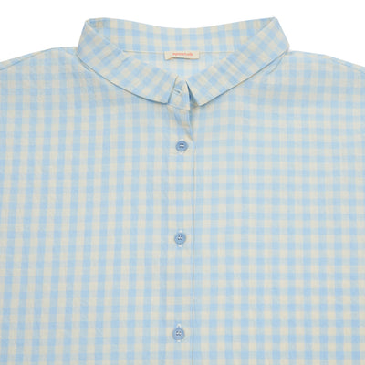 A relaxed shirt with full button closure and miniature collar. This style is oversized, with dropped shoulders, full-length sleeves, and is crafted from a lightweight cotton blend.  99% Cotton, 1% Elastane.