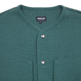 Close up: George Cardigan in Emerald made from warm merino wool. Featuring four handy storage patch pockets, a collarless neckline, and metal snap button closure.  100% merino wool.
