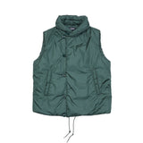 Loft Technical Nylon Vest in Emerald is a padded layering piece for extra warmth. Featuring off-centre button closure to keep the cold out, front slash pockets, and a miniature shawl neckline that can be turned up against the elements. The waist has an adjustable drawstring for fit and to keep cosy.  100% nylon. Filling: 100% Polyamide Primaloft insulation.