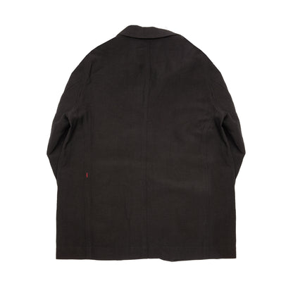 Casey Casey Jak Pat  Reversible Jacket in Black. A three-button jacket with button flap pockets and lapels.