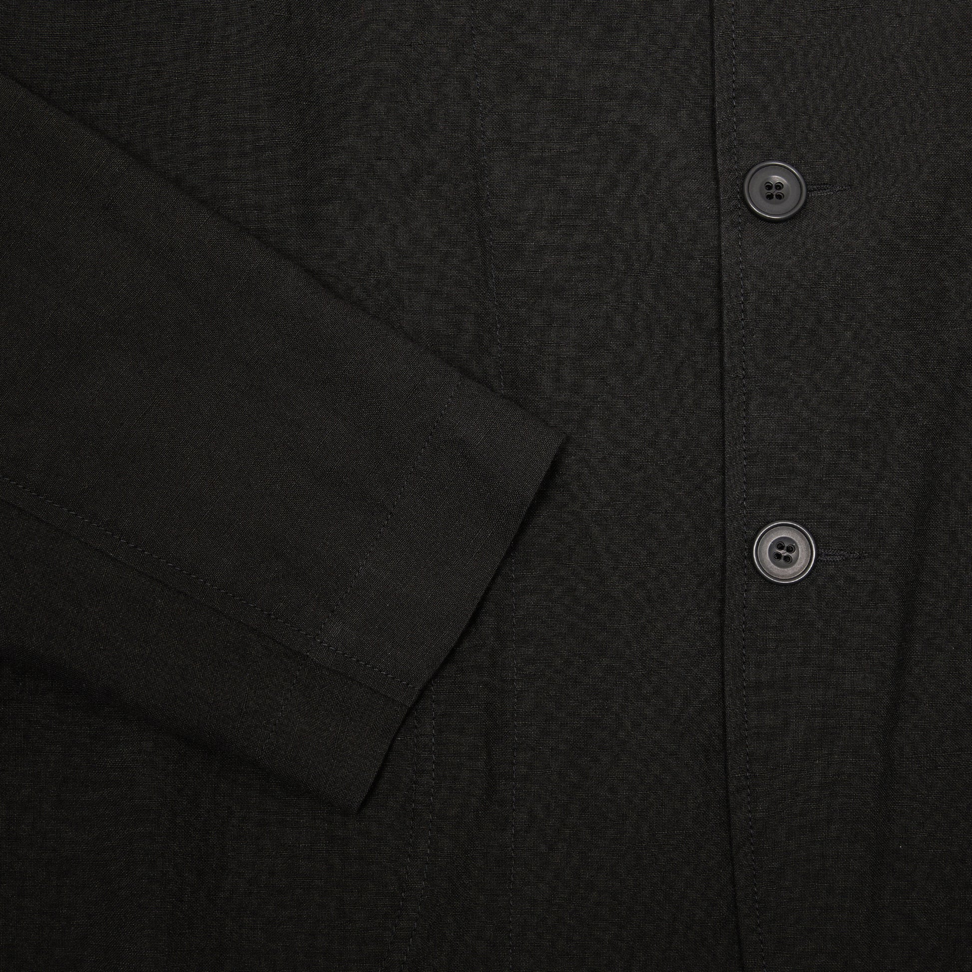 Casey Casey Jak Pat  Reversible Jacket in Black. A three-button jacket with button flap pockets and lapels.