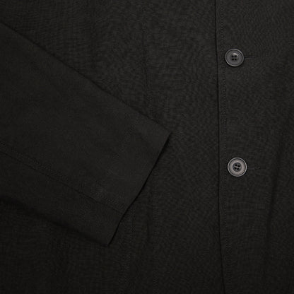 Casey Casey Jak Pat  Reversible Jacket in Black. A three-button jacket with button flap pockets and lapels.