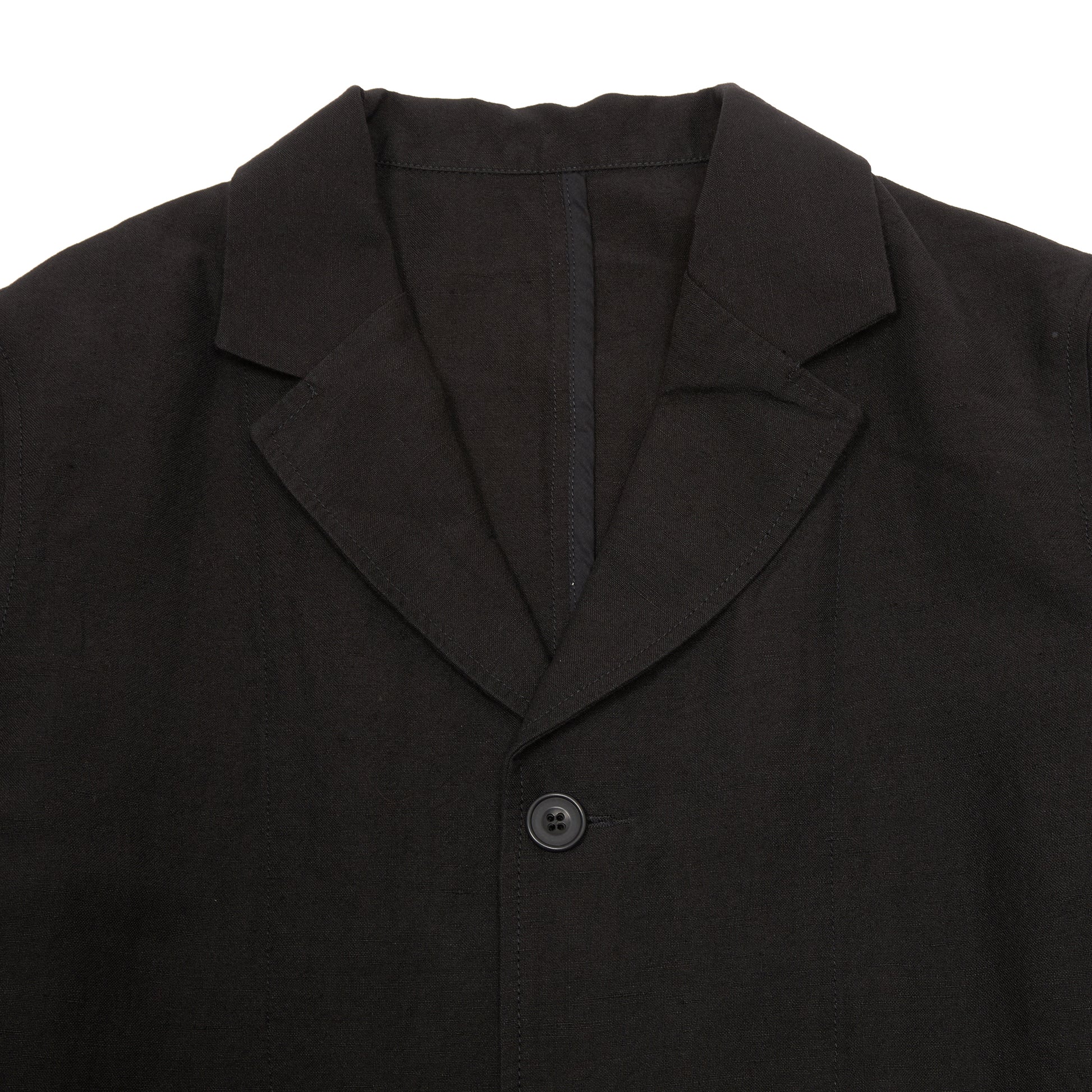 Casey Casey Jak Pat  Reversible Jacket in Black. A three-button jacket with button flap pockets and lapels.