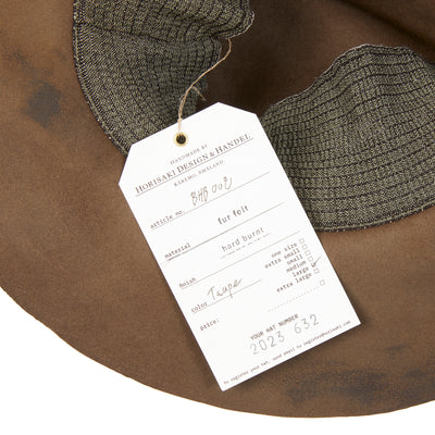 A beaver fur felt hat with a curved brim, teardrop crown, and pinched front. Featuring a stretch lining and is mouldable. With a hard burnt finish, this style will continue to develop a unique patina across time and use.  100% Beaver Fur Felt.  Made by hand in Sweden. 