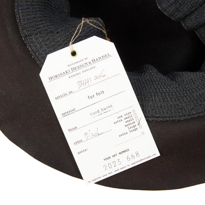 A beaver fur felt hat in a crushed style. Featuring a stretch lining, and is mouldable and foldable. With a hard burnt finish, this style will continue to develop a unique patina across time and use.  100% Beaver Fur Felt.  Made by hand in Sweden. 