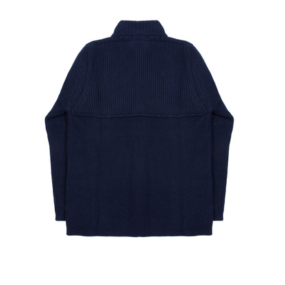 In solid navy, the Storm Jacket from Inis Meáin is inspired by island life and outdoor working in all weathers. Featuring knitted shoulder patches providing additional warmth and protection, patch pockets, a funnel collar, and finished with real horn buttons. The Storm Jacket is both functional and elegant.  70% Merino Wool, 30% Cashmere.   Made in Ireland.