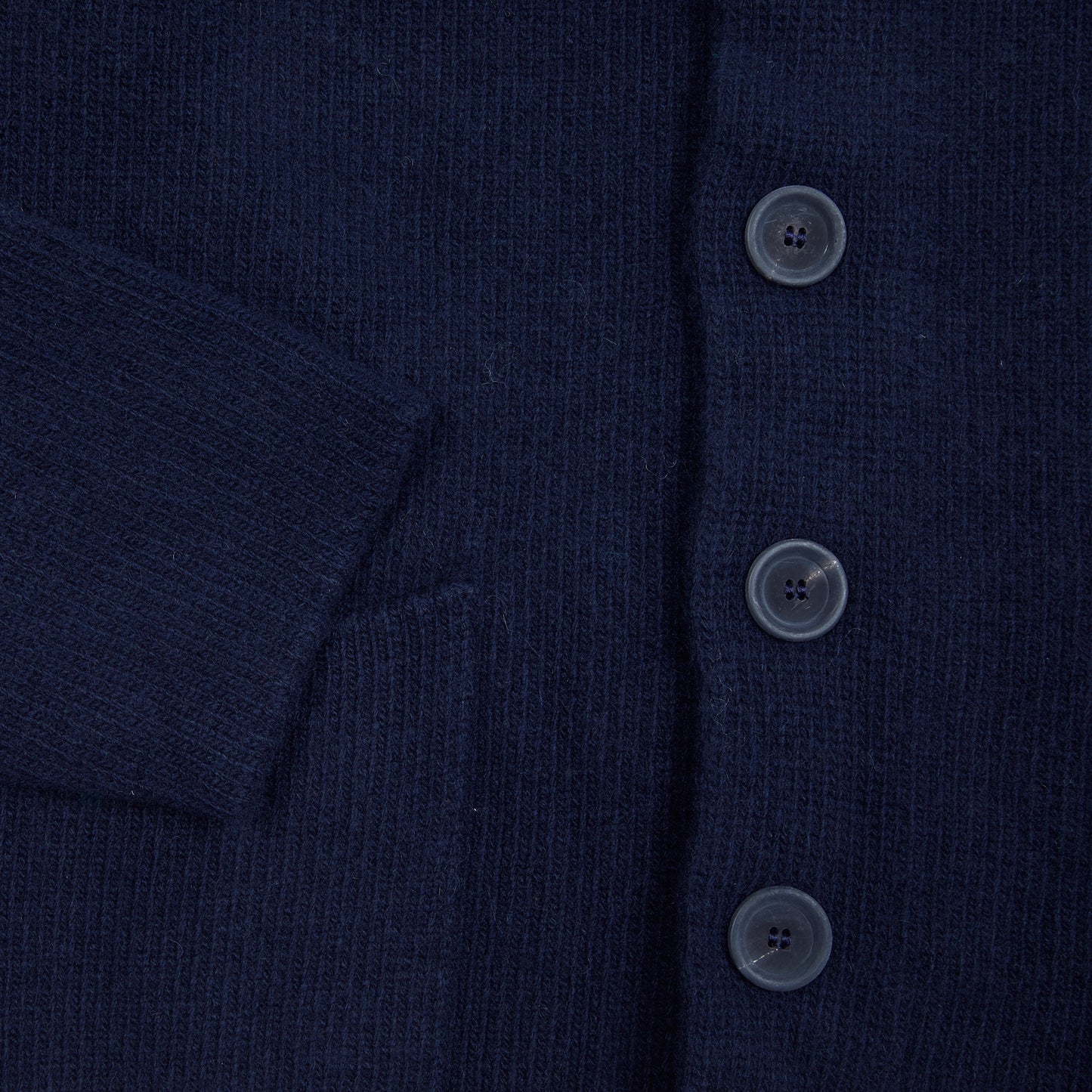 In solid navy, the Storm Jacket from Inis Meáin is inspired by island life and outdoor working in all weathers. Featuring knitted shoulder patches providing additional warmth and protection, patch pockets, a funnel collar, and finished with real horn buttons. The Storm Jacket is both functional and elegant.  70% Merino Wool, 30% Cashmere.   Made in Ireland.
