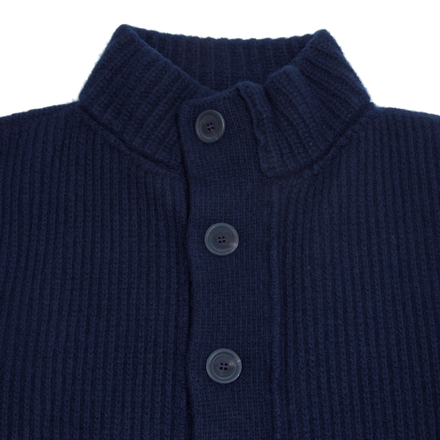 In solid navy, the Storm Jacket from Inis Meáin is inspired by island life and outdoor working in all weathers. Featuring knitted shoulder patches providing additional warmth and protection, patch pockets, a funnel collar, and finished with real horn buttons. The Storm Jacket is both functional and elegant.  70% Merino Wool, 30% Cashmere.   Made in Ireland.