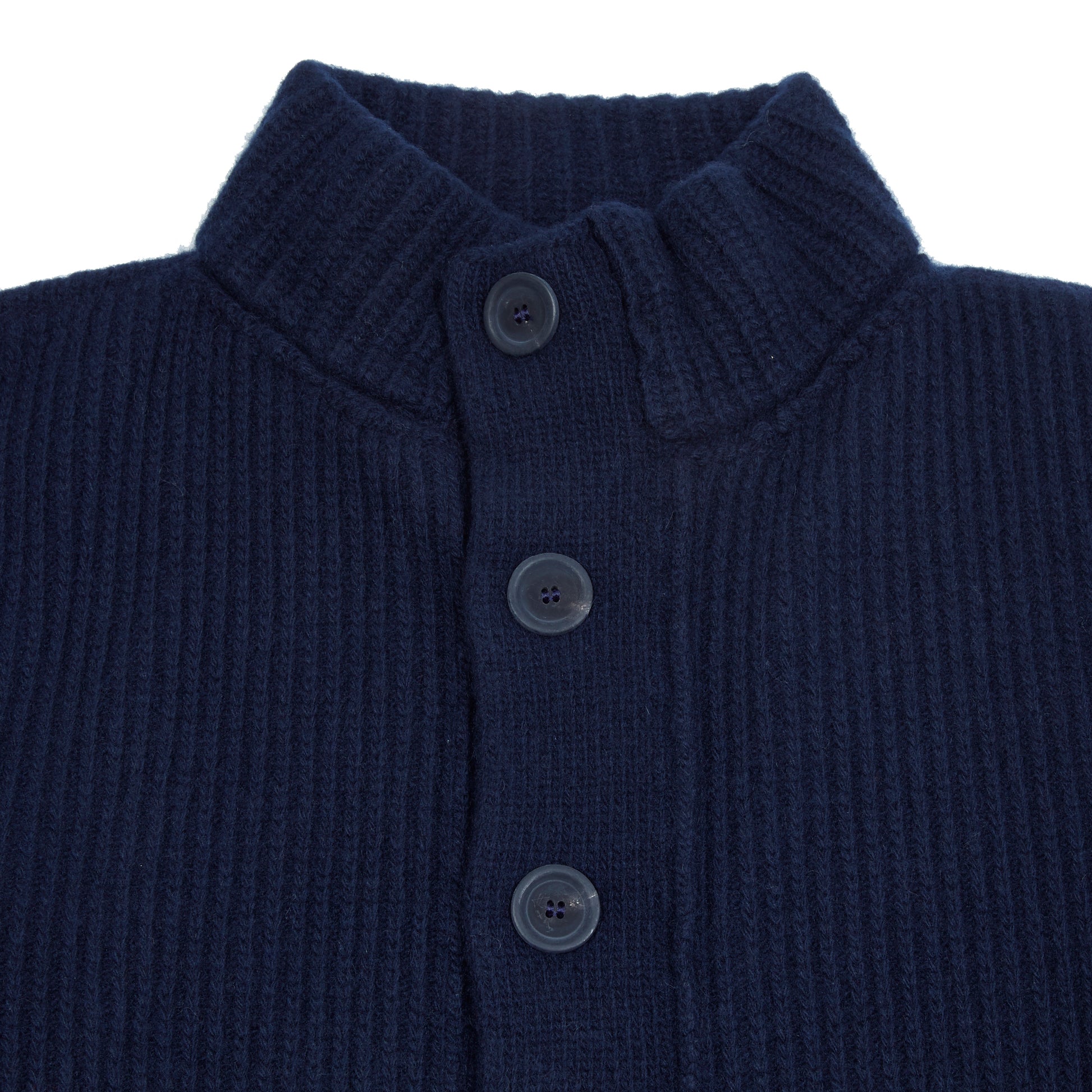 In solid navy, the Storm Jacket from Inis Meáin is inspired by island life and outdoor working in all weathers. Featuring knitted shoulder patches providing additional warmth and protection, patch pockets, a funnel collar, and finished with real horn buttons. The Storm Jacket is both functional and elegant.  70% Merino Wool, 30% Cashmere.   Made in Ireland.
