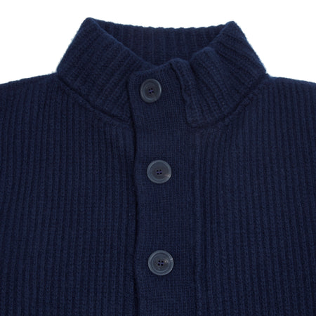 In Marino blue, the Storm Jacket from Inis Meáin is inspired by island life and outdoor working in all weathers. Featuring knitted shoulder patches providing additional warmth and protection, patch pockets, a funnel collar, and finished with real horn buttons. The Storm Jacket is both functional and elegant.  70% Merino Wool, 30% Cashmere.   Made in Ireland.