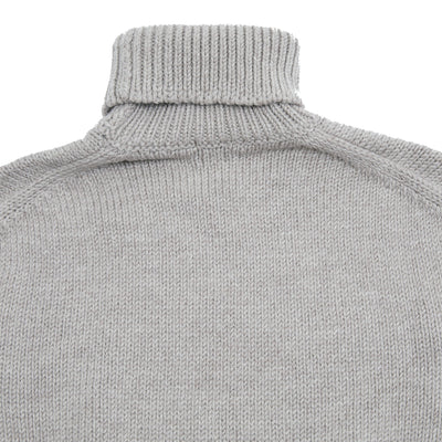 Rory Rollneck Sweater is an oversized cut with an asymmetric hem and exaggerated contrast rib detailing on hem and cuffs. This style features a drop shoulder, central seam detail on the front, and splits in the hem and cuffs for added comfort. A midweight knit with a soft hand.  100% Wool.  Made in Italy.