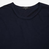 A cotton jersey long-sleeve t-shirt with dropped shoulders and raw hem finishes. This style features a curved hem with notch detail, and twisted side seams.  100% Cotton.  Made in Japan.