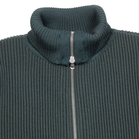 The Veritas Full-Zip is a high-neck zip up cardigan featuring distinctive knitted ribbed texture. It has a regular fit, RIRI zippers and is made of a heavy weight virgin wool.  100% virgin wool.  Knitted in Latvia.