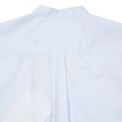 Botanist collarless shirt in cotton poplin. The cut is fitted on the shoulders with a gentle flare on the body, with overlapping side detail and curved hem. Half placket with tonal buttons.  100% Cotton.  Made in Portugal.