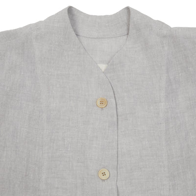 The Chandler Shirt in linen has grown-on cap sleeves and a high curved neckline. Crafted from a crisp linen, this short boxy shape will keep you cool on the hottest of summer days.  100% Linen.  Made in Poland.