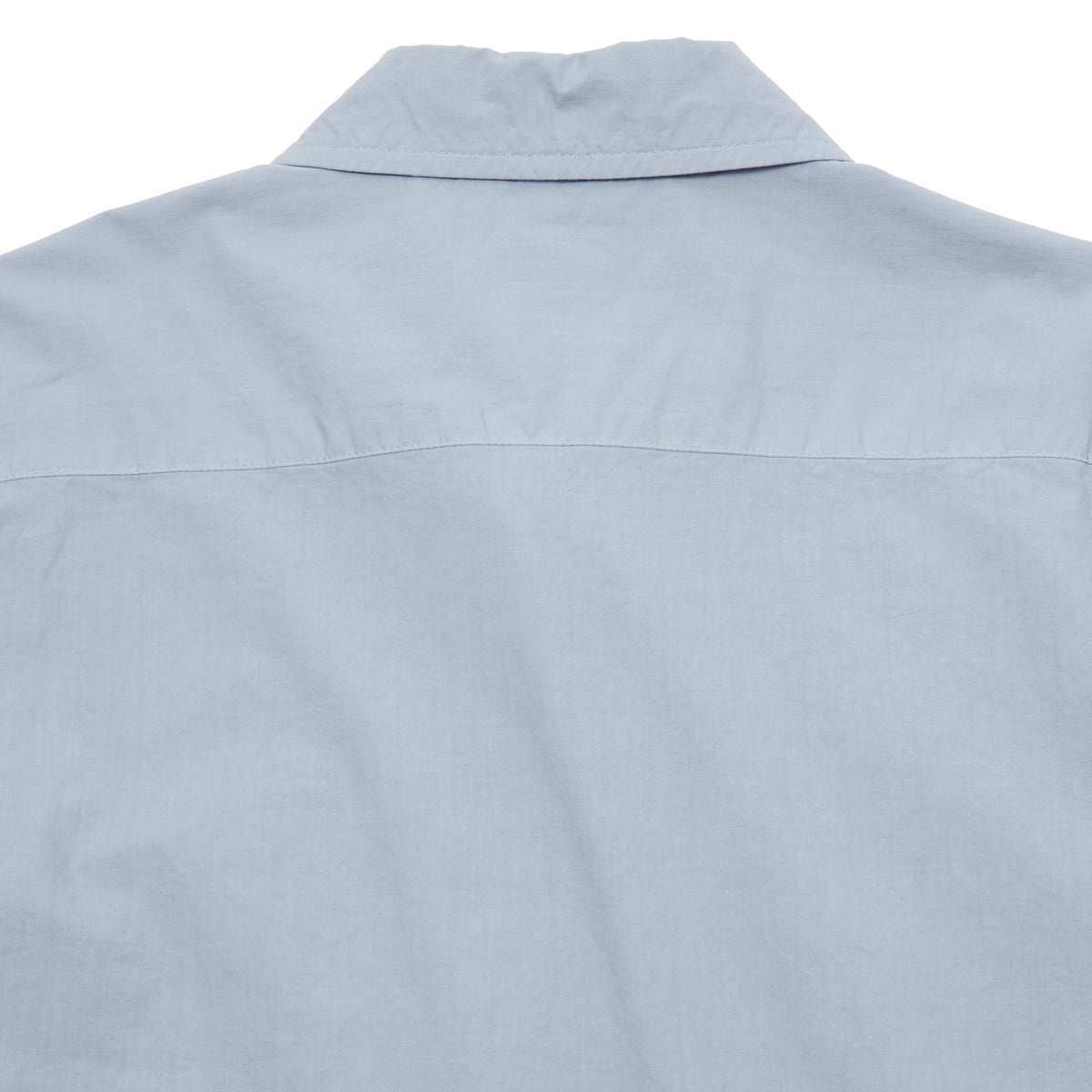 Sage de Cret Cotton Shirt in Saxe is a classic long-sleeve shirt in organic cotton broadcloth. Relaxed cut with curved hem, one chest patch pocket and finished with mother of pearl buttons. Garment washed to give intentional creases for that 'worn in' look.  100% cotton.  Made in Japan.