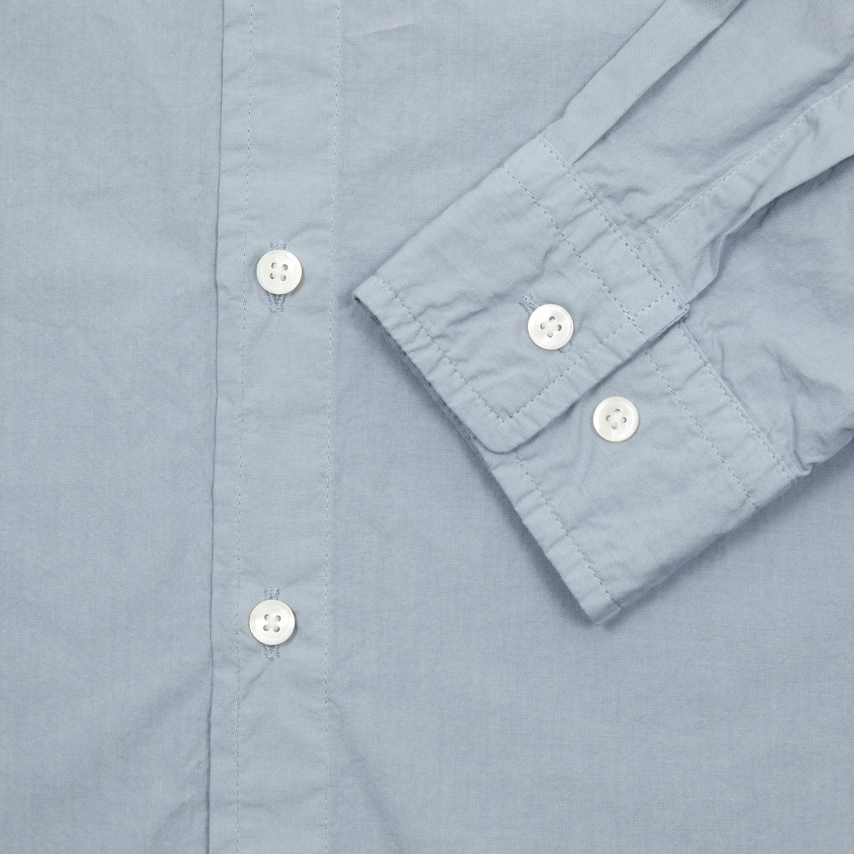 Sage de Cret Cotton Shirt in Saxe is a classic long-sleeve shirt in organic cotton broadcloth. Relaxed cut with curved hem, one chest patch pocket and finished with mother of pearl buttons. Garment washed to give intentional creases for that 'worn in' look.  100% cotton.  Made in Japan.