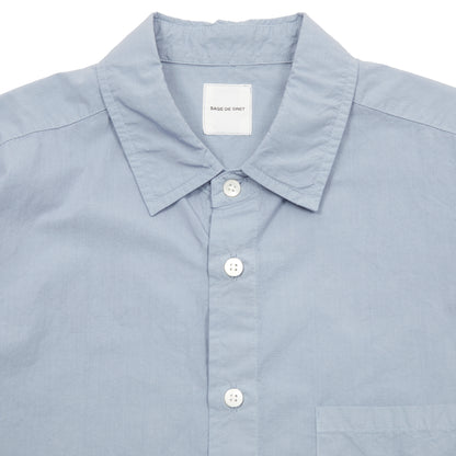 Sage de Cret Cotton Shirt in Saxe is a classic long-sleeve shirt in organic cotton broadcloth. Relaxed cut with curved hem, one chest patch pocket and finished with mother of pearl buttons. Garment washed to give intentional creases for that 'worn in' look.  100% cotton.  Made in Japan.