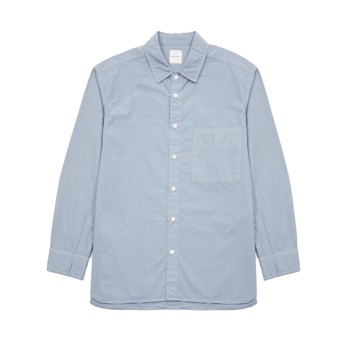 Sage de Cret Cotton Shirt in Saxe is a classic long-sleeve shirt in organic cotton broadcloth. Relaxed cut with curved hem, one chest patch pocket and finished with mother of pearl buttons. Garment washed to give intentional creases for that 'worn in' look.  100% cotton.  Made in Japan.
